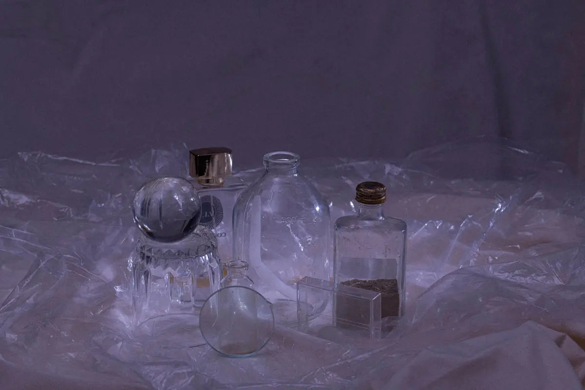 a group of glass bottles sitting on top of a table